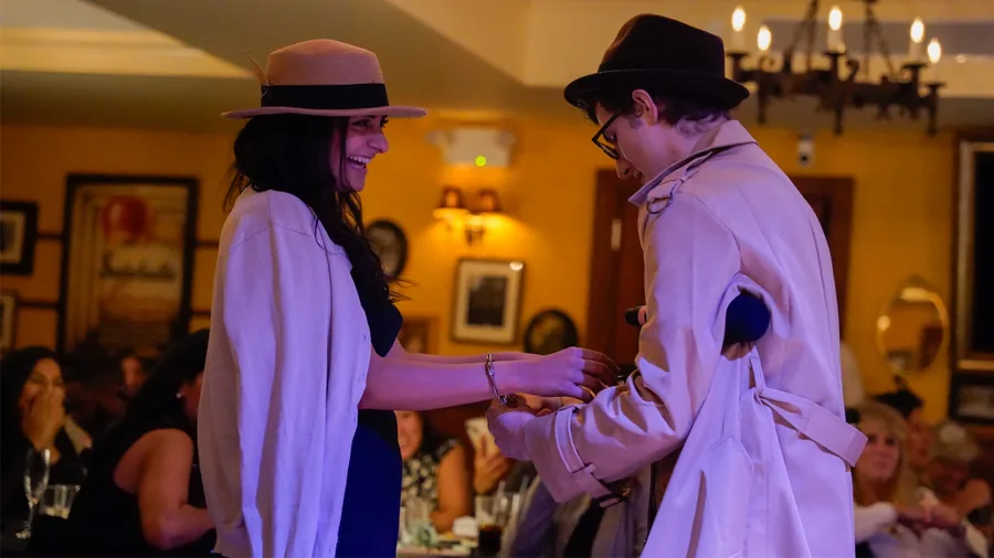 A Murder Mystery Company detective questioning a guest at a San Jose show